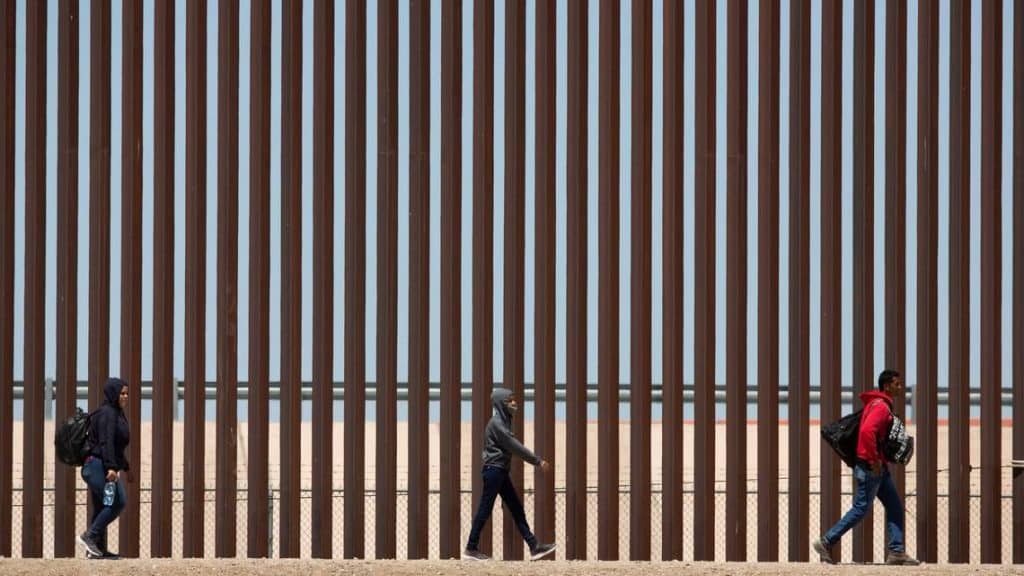 Migrants await to be processed at gate 40 of the border wall after having crossed the Rio Grande from Ciudad Juarez in hopes of turning themselves in with the intention of seeking asylum. OMAR ORNELAS USA TODAY NETWORK