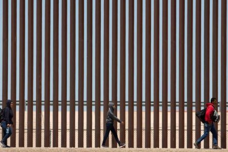 Migrants await to be processed at gate 40 of the border wall after having crossed the Rio Grande from Ciudad Juarez in hopes of turning themselves in with the intention of seeking asylum. OMAR ORNELAS USA TODAY NETWORK